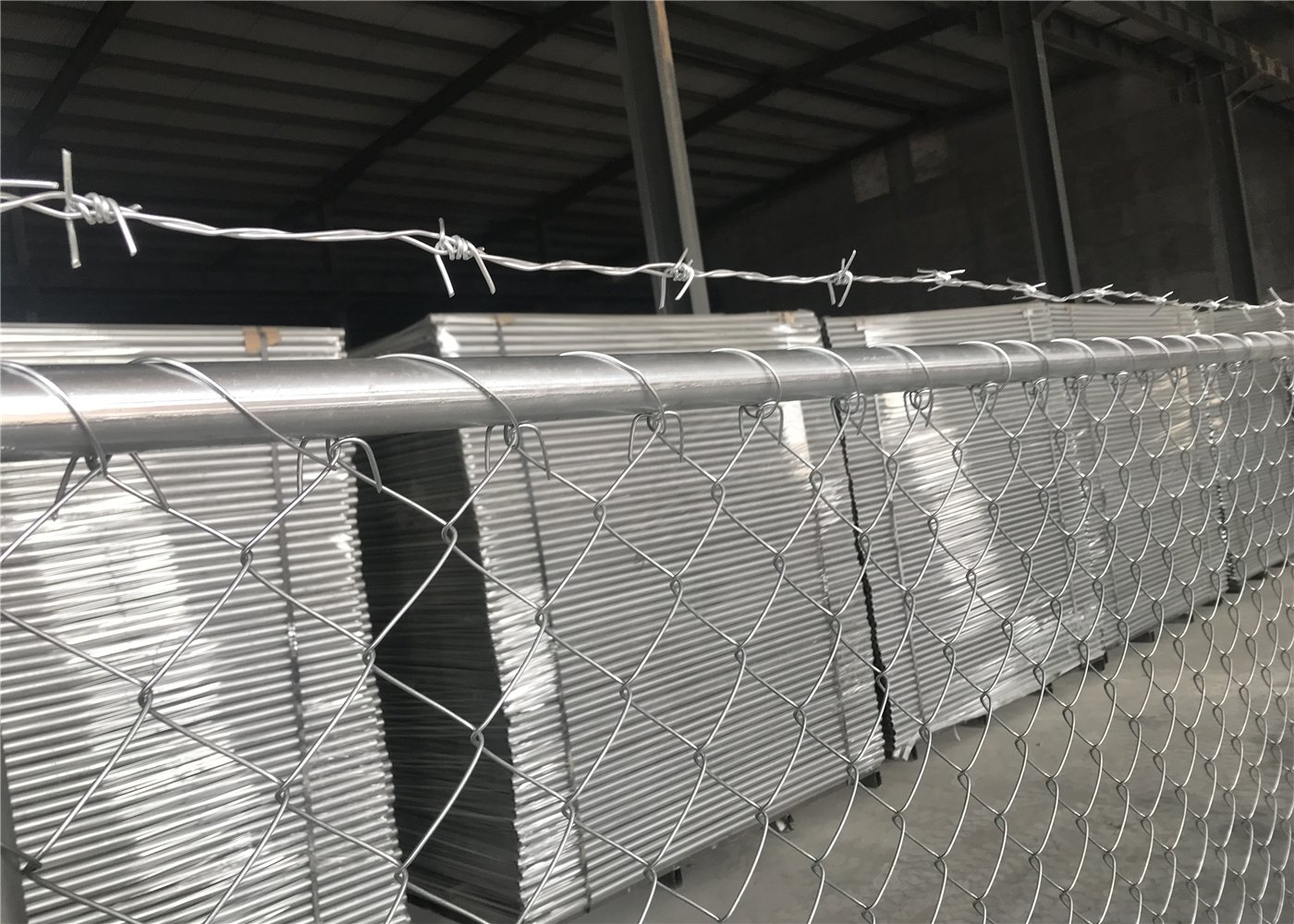 chain link fence panels with barbed wire tops